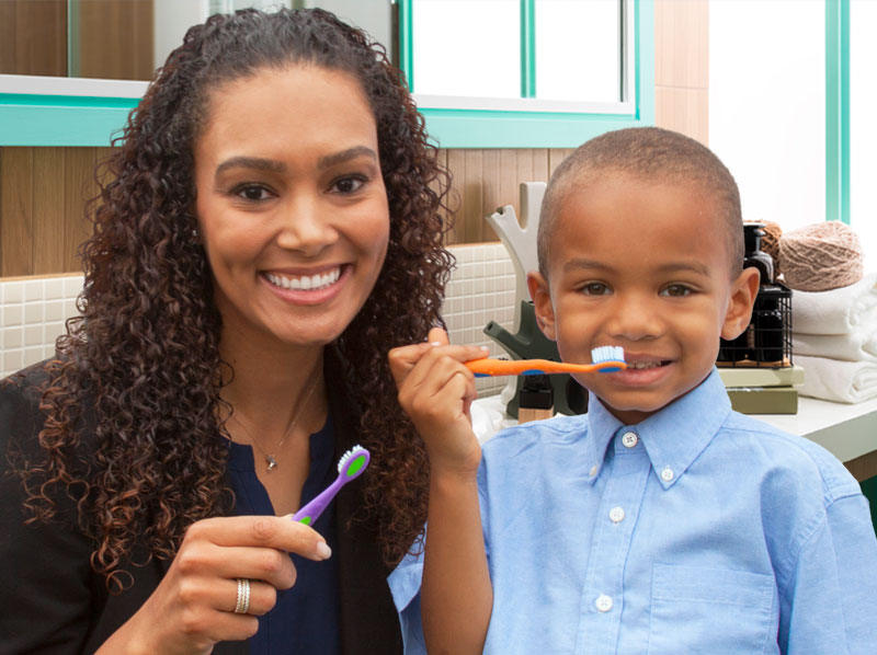 Mother and son brushing their teeth in the bathroom